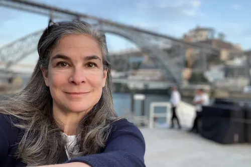 Pauline Frommer in front of a bridge in Porto, Portugal