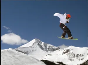 A snowboarder challenges himself at Big Sky Resort. Montana